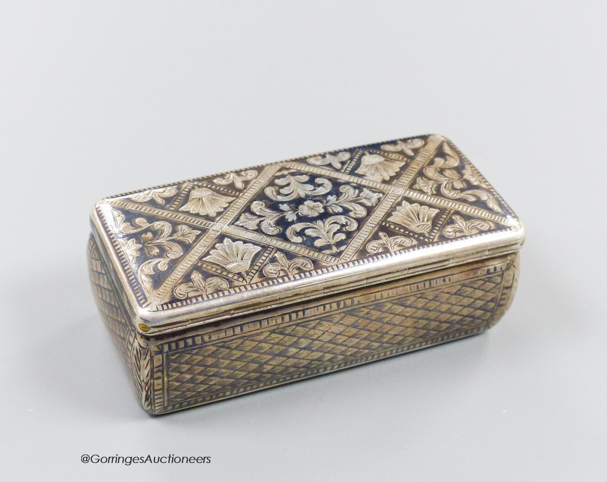 A 19th century Russian 84 zolotnik and niello rectangular snuff box, with trellis and scroll decoration, 87mm, (date rubbed), 107 grams.